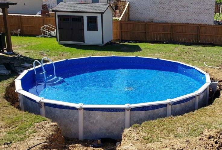 an above ground swimming pool is shown in the backyard with grass and fence around it