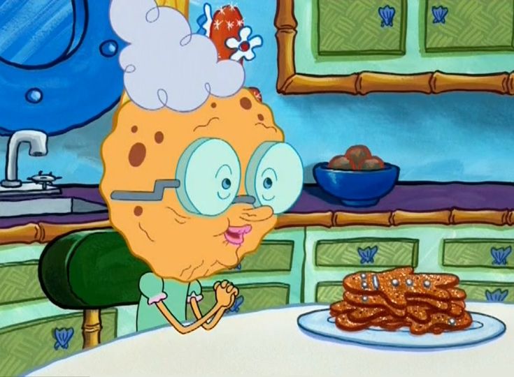 a cartoon character sitting at a table in front of a plate of fried sausages