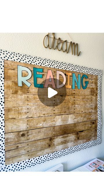 a wooden sign that reads reading with polka dots on the bottom and an arrow above it