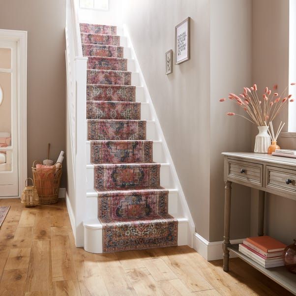 there is a stair case on the wall in this room, and it has carpeted stairs