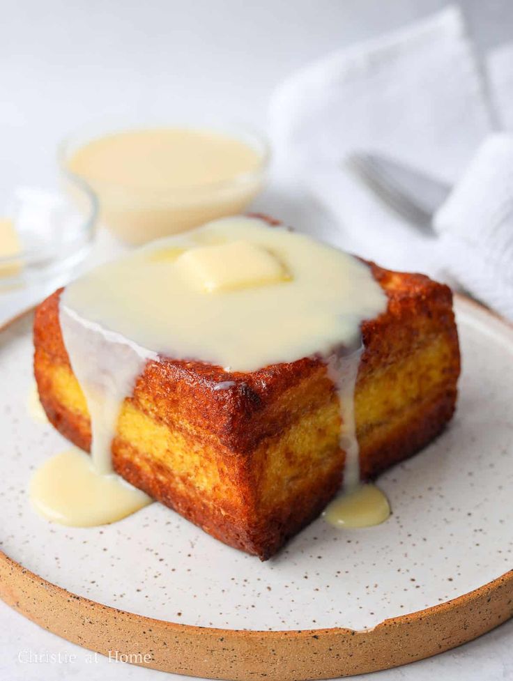 a piece of cake sitting on top of a plate covered in icing and sauce