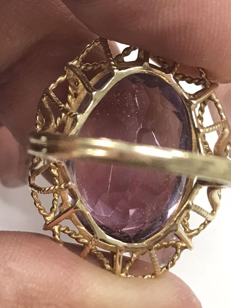 VINTAGE AMETHYST 14K YELLOW GOLD FILIGREE RING Unique and rare design, Fine Oval Amethyst Solitaire Ring approximately 15ct, set in a gorgeous filagree design band. There is a scratch/crack in back of stone. (see pics) Does not go through. It is not really visible from front, I've worn and never noticed until photographing now. Price reflects this. This item is vintage and beautiful that is sure to be one of your favorite pieces! Oval cut Amethyst totaling approximately 15 CTW! Measures approxim Collectible Oval 14k Gold Rings, Oval Amethyst Ring Stamped 14k, Oval 14k Gold Rings For Collectors, Collectible 14k Gold Oval Rings, Collectible Yellow Gold Oval Rings, Oval Yellow Gold Rings, Vintage Oval Amethyst Ring In 14k Gold, Yellow Gold Oval Gemstones Fine Jewelry, Oval Yellow Gold Gemstones Fine Jewelry