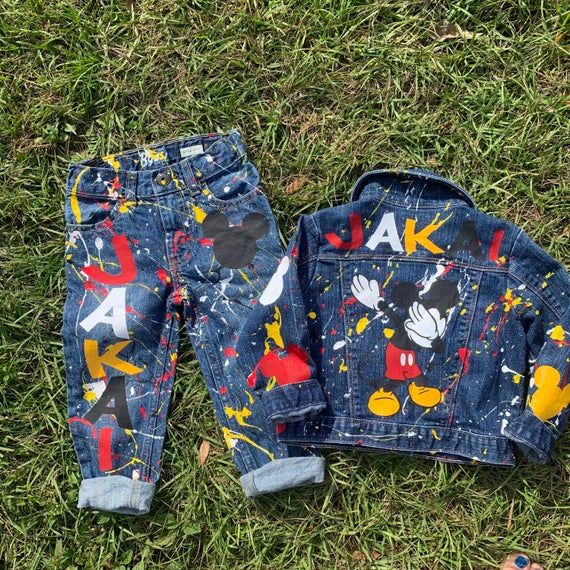 a mickey mouse denim jacket and pants on the grass