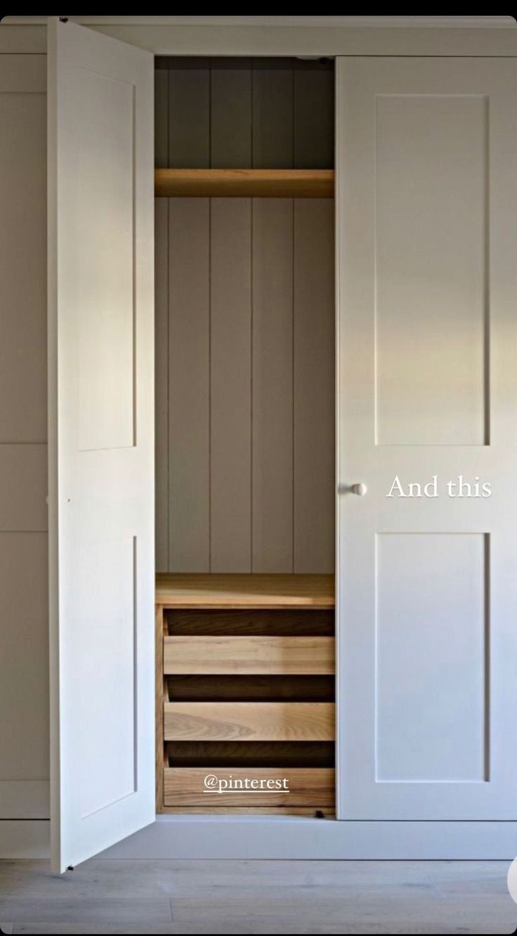 an empty closet with white doors and drawers on the bottom shelf is shown in this image