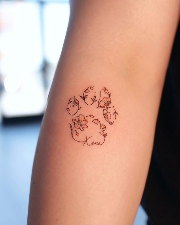 a person with a tattoo on their arm that has cats in the shape of a circle