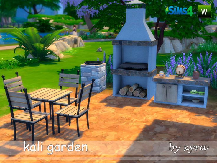 an outdoor kitchen and dining area in the middle of a garden