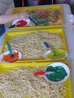 two trays filled with different types of noodles on top of a table next to each other