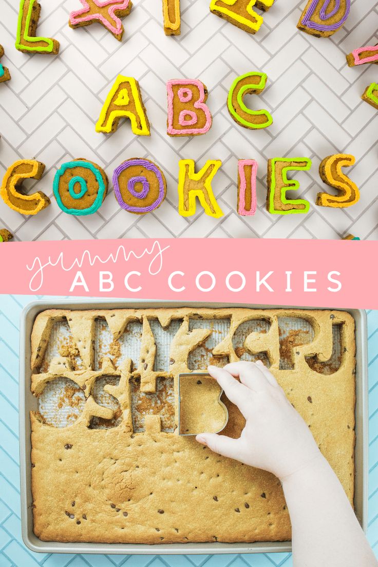 a cookie with the words abc cookies written on it and someone cutting out letters in front of them