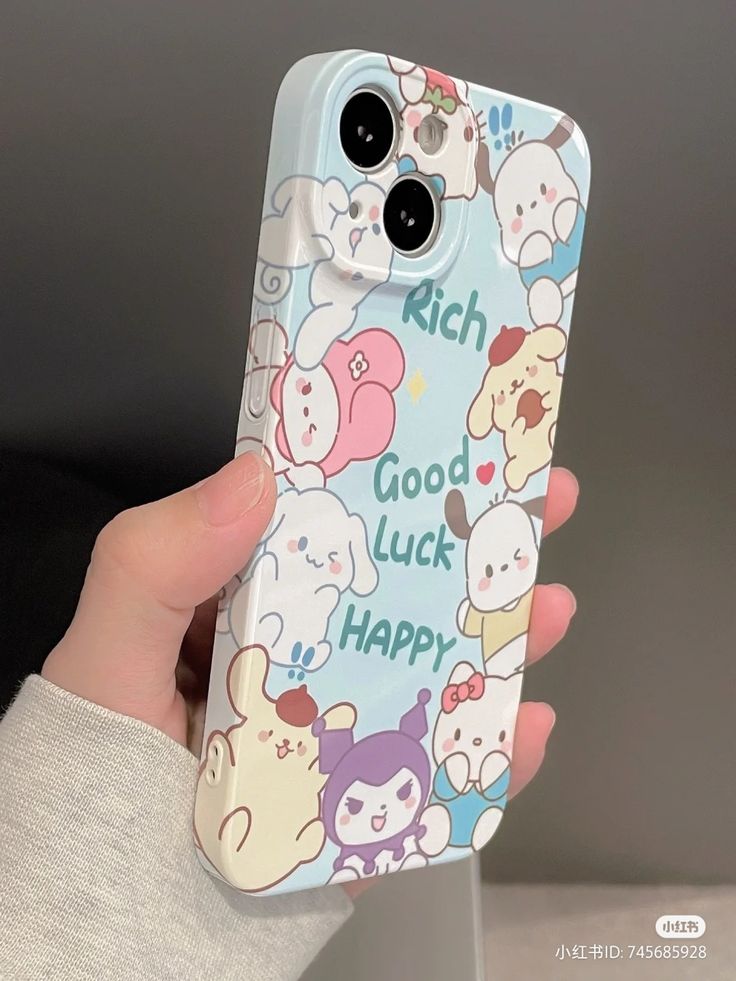 a person holding up a phone case with cartoon characters on it's back and the words, rich luck happy