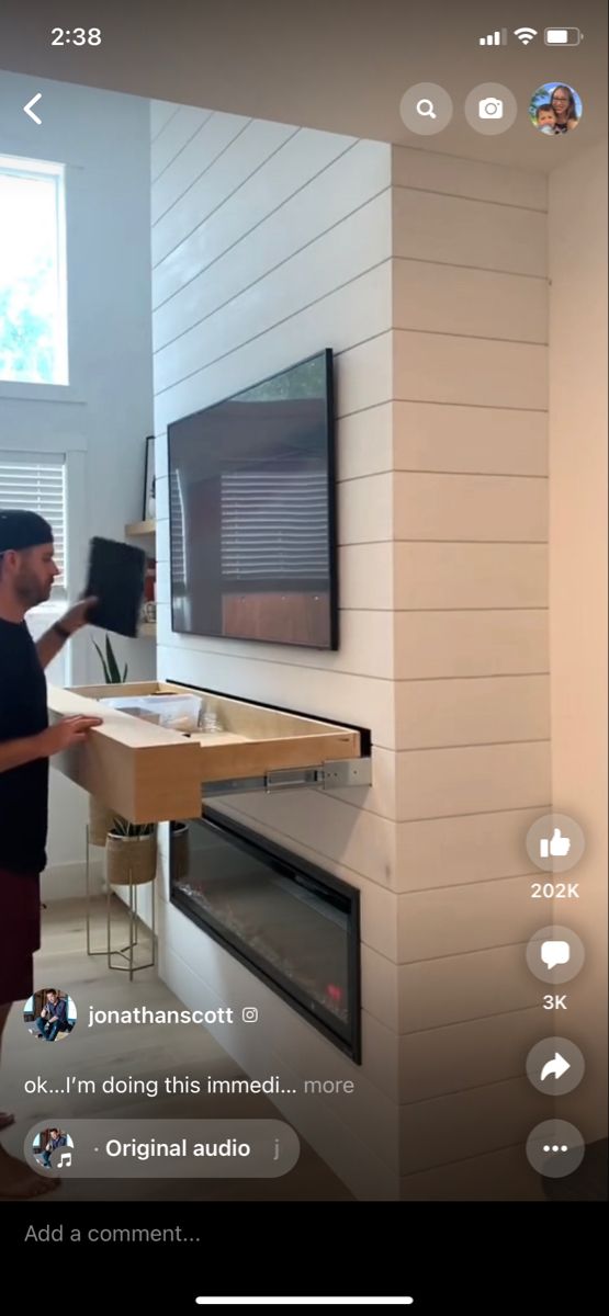 a man standing in front of a flat screen tv