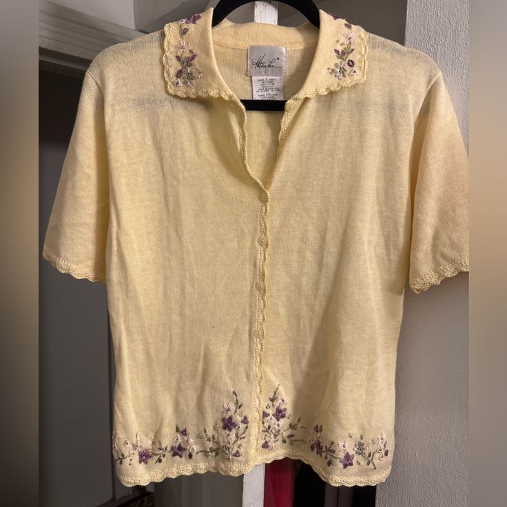 Pastel Yellow Short Sleeve Sweater With Embroidered Flowers. Also Has A Pretty Scalloped Trim. Vintage, But New Condition. Yellow Embroidered Tops For Fall, Casual Yellow Embroidered Tops, Yellow Crew Neck Top With Floral Embroidery, Fitted Yellow Tops With Floral Embroidery, Fitted Embroidered Yellow Tops, Fitted Yellow Embroidered Tops, Taupe Cardigan, Rose Cardigan, Merino Wool Cardigan