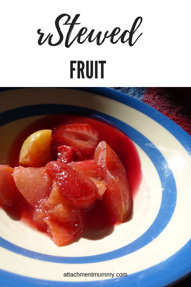 a blue and white plate topped with fruit covered in sauce next to a red towel