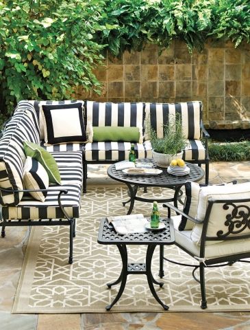 an outdoor patio with black and white striped furniture