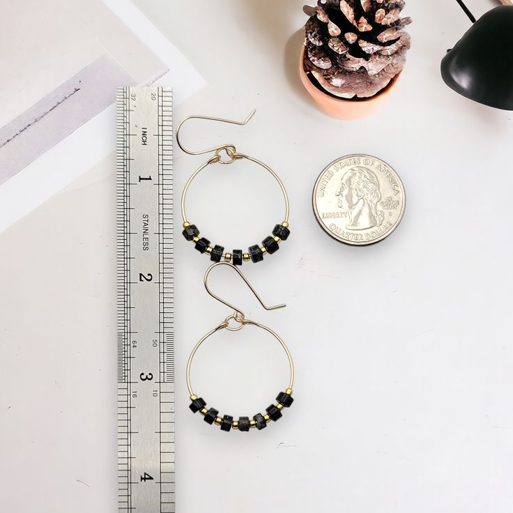 These gold hoops, adorned with black jasper beads, add a touch of eclectic elegance to any outfit. Perfect for any boho babe, these earrings are a must-have for your collection. 14k Gold Filled Wire Measure approximately 1.125" in diameter Earrings Hang 1.75" from top of ear wire Black Jasper Gemstones Polished to a high shine Sent in a Gift Box with Polishing Cloth Handmade in Montana 14k Gold Filled Beaded Round Earrings, Handmade Black Beaded Small Hoop Earrings, Small Black Hoop Earrings For Jewelry Making, Black Beaded Round Hoop Earrings, Black Hoop Earrings For Everyday, Black Everyday Hoop Earrings, Everyday Black Hoop Earrings, Adjustable Hoop Earrings With Black Beads, Small Black Hoop Earrings For Everyday