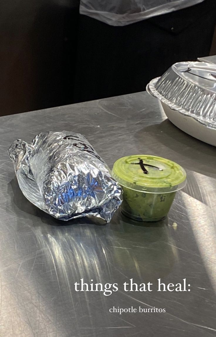 an aluminum table with some food on it and a tin foil container next to it