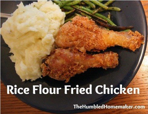 fried chicken, mashed potatoes and green beans on a black plate with the words rice flour fried chicken