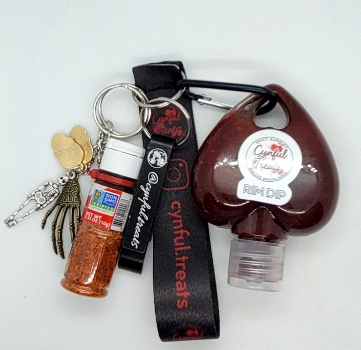 an assortment of items are displayed on a white surface, including a bottle opener and keychain