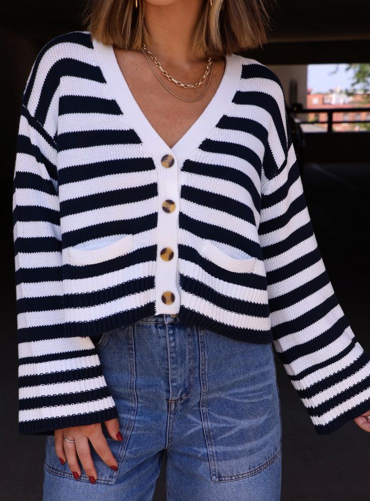 This Newport Striped Cardigan is the perfect blend of style and comfort. Made with a classic striped pattern, it features a button-down front and versatile bell sleeves. Whether you're looking to dress it up or down, this cardigan is sure to become a staple in your wardrobe. Fabric 55% cotton, 45% acrylic Chic Striped Cardigan For Fall, Striped V-neck Cardigan For Work, Chic Striped Long Sleeve Cardigan, Spring Striped Workwear Cardigan, Casual Striped Ribbed Cardigan, Striped Cardigan With Button Closure For Work, Trendy Striped Cardigan For Fall, Casual Fall Cardigan With Striped Cuffs, Chic Striped Cardigan For Spring