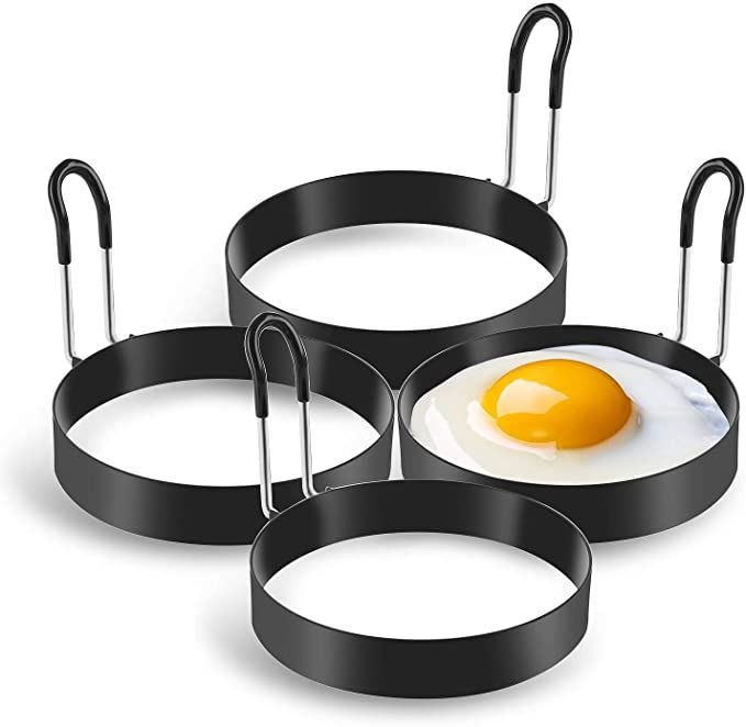 three frying pans with an egg in the middle and two on each side