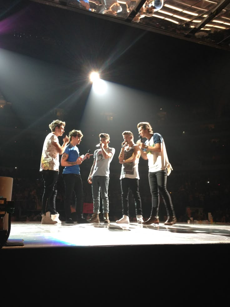 a group of young men standing on top of a stage