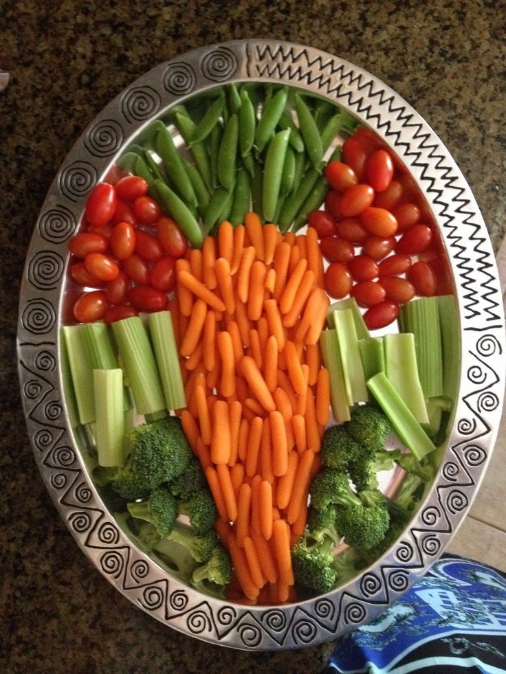 a bowl filled with carrots, celery and broccoli on top of a table