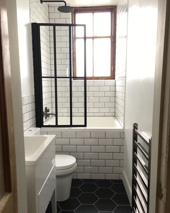 a white toilet sitting next to a window in a bathroom