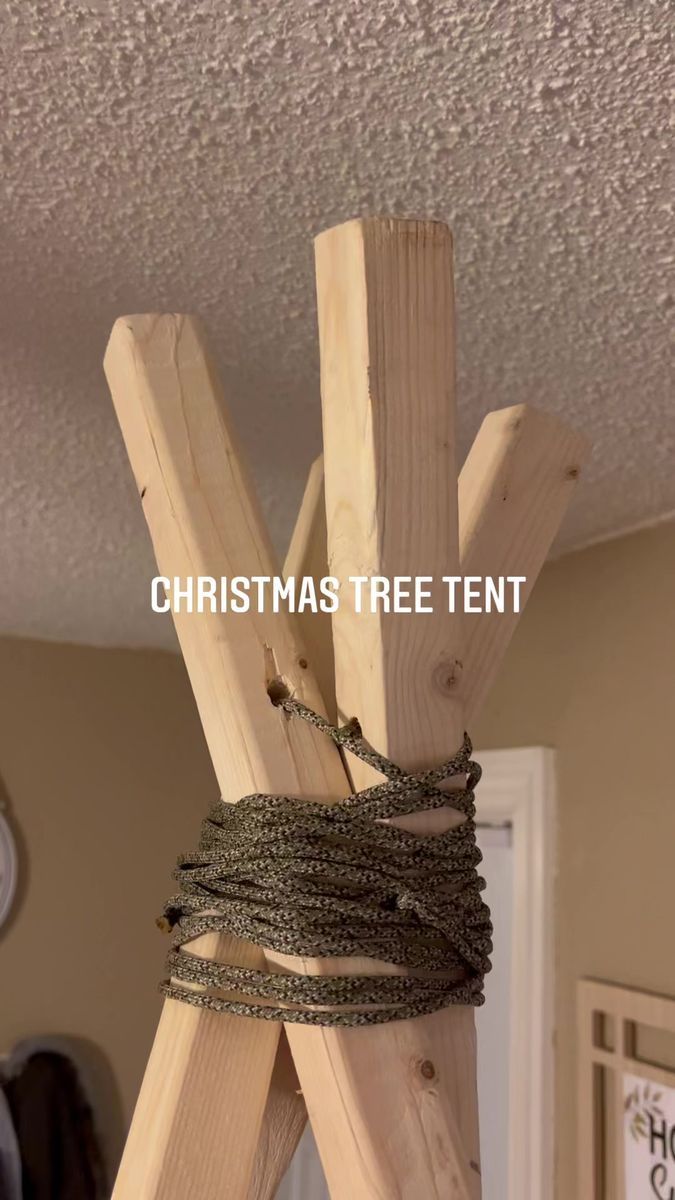 a christmas tree tent made out of wood and rope with the words christmas tree tent on it