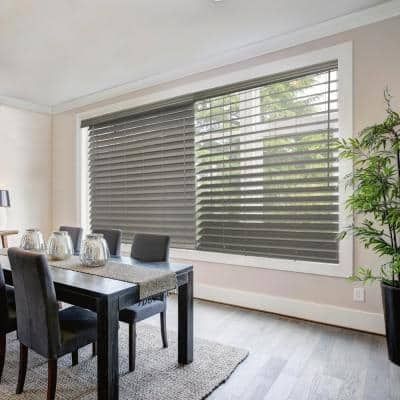 a dining room table and chairs with blinds in the window