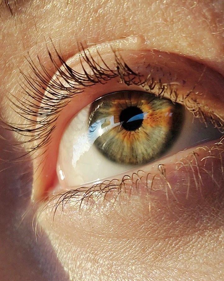 an extreme close up shot of someone's eye with the iris partially closed and visible