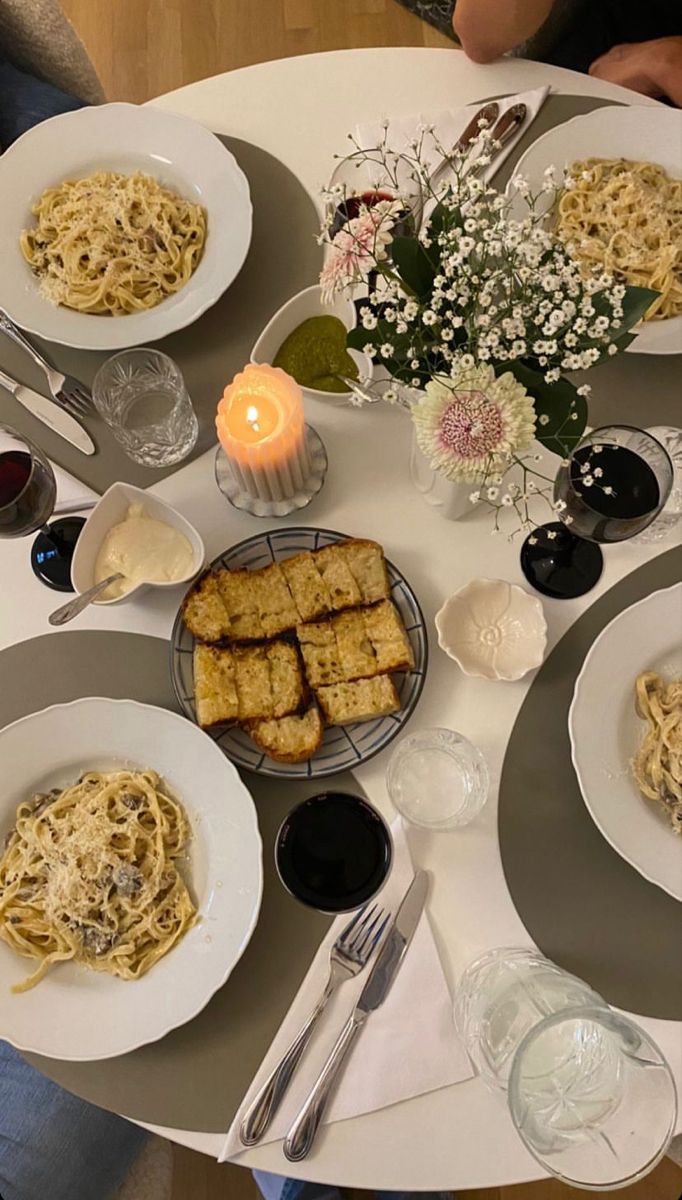 a white table topped with plates of food