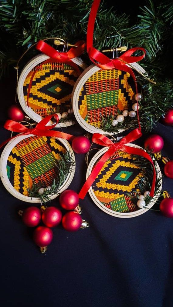 three ornaments are hanging from a christmas tree