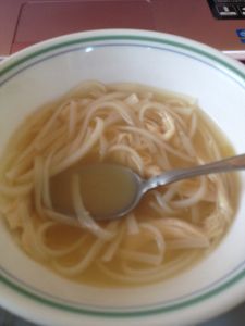 a bowl of noodles with a spoon in it