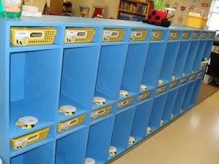 a row of blue lockers with yellow lids in a school library or playroom