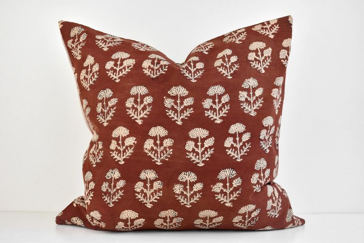 a brown pillow with white flowers on it