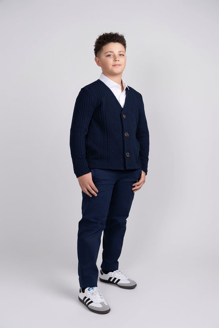 Introducing our Navy Chunky Knit Cardigan – the perfect blend of style, warmth, and comfort for your young trendsetter. The rich navy hue complements any outfit, making it a versatile addition to his wardrobe for both casual and semi-formal occasions. Featuring a classic design, this cardigan is adorned with large brown buttons that not only serve as functional closures but also add a charming contrast to the deep navy fabric. Navy Long Sleeve Winter Cardigan, Navy Knit Outerwear For Winter, Navy Knit Winter Outerwear, Navy Cardigan For Fall, Casual Navy Cardigan For Fall, Navy Cotton Cardigan For Winter, Navy Cotton Winter Cardigan, Navy Cotton Cardigan For Fall, Navy Casual Peacoat For Fall