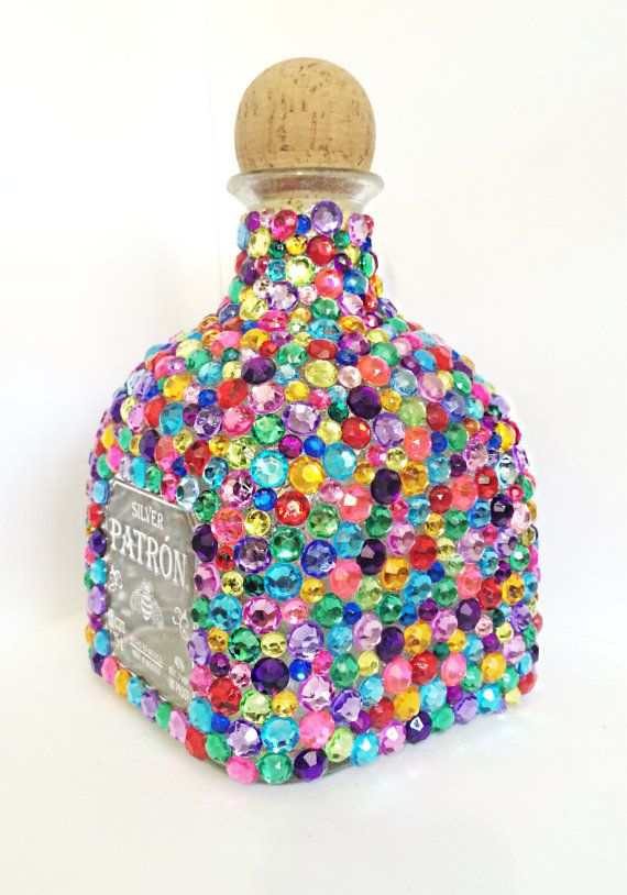 a bottle filled with lots of colorful beads