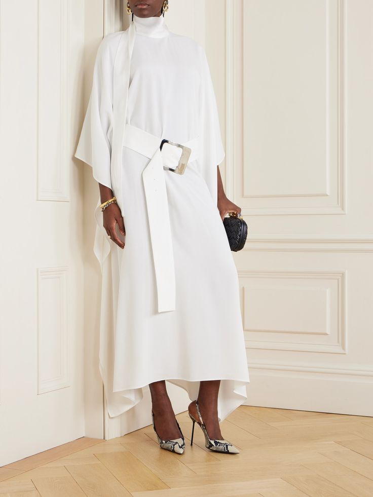 Taller Marmo's designs are inspired by the glamorous eveningwear worn by icons such as Elizabeth Taylor and Sophia Loren. Cut from fluid cady, this 'La Luna' kaftan has a loose silhouette and high neckline that flows into a fluttery scarf. Cinch the waist with the oversized '70s-inspired belt. White Silk Crepe Formal Dress, Elegant White Silk Crepe Dress, Formal White Silk Crepe Dress, Elegant Evening Kaftan For Spring, Elegant Maxi-length Kaftan, Formal Silk Fitted Kaftan, Elegant Silk Kaftan, Elegant Fitted Maxi Length Kaftan, Elegant Silk Maxi Kaftan