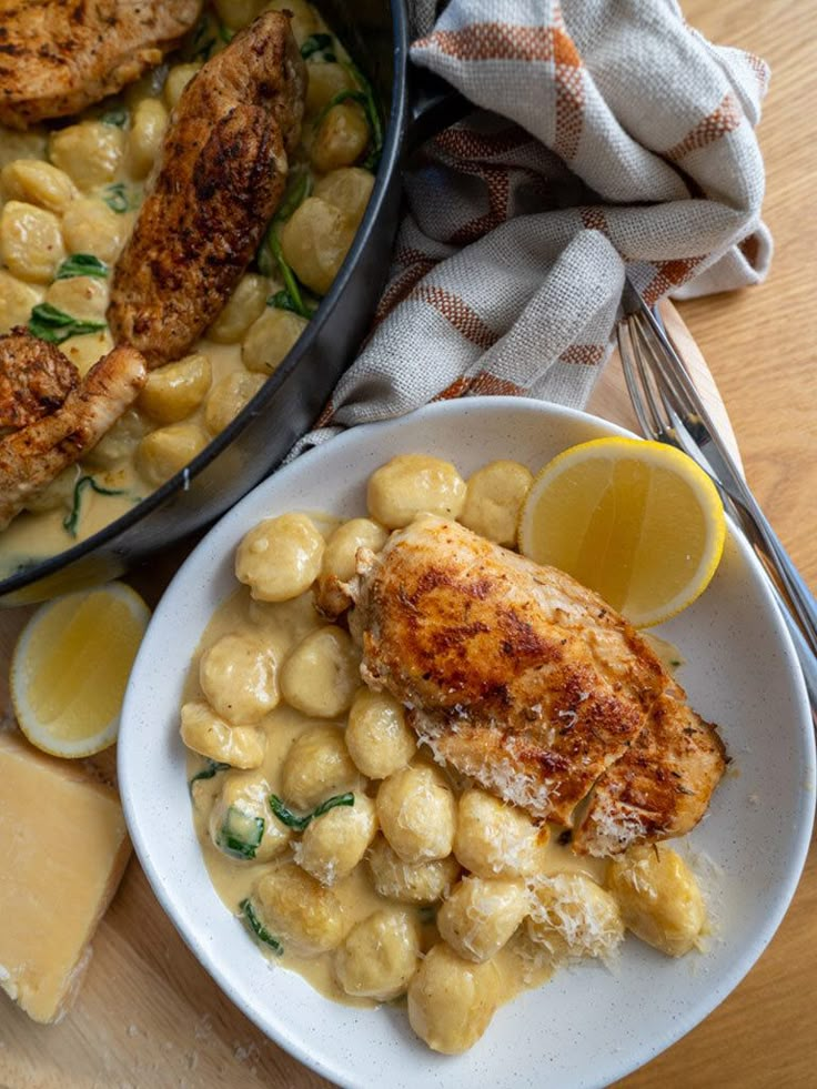 the meal is ready to be eaten and served on the table with lemon wedges