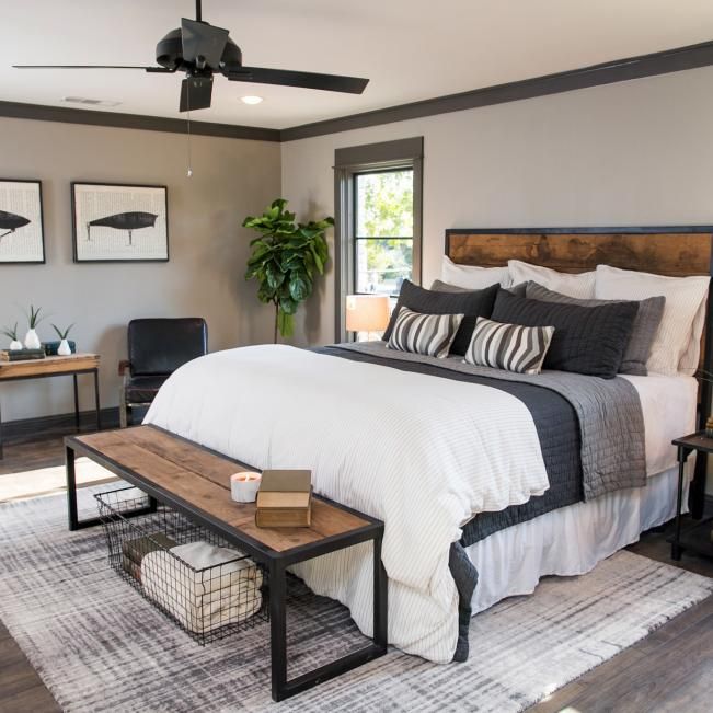 a large bed sitting in a bedroom on top of a hard wood floor