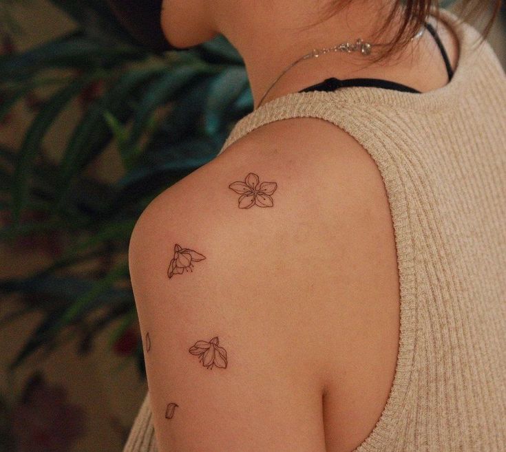 a woman with a butterfly tattoo on her shoulder