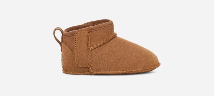 This Classic Ultra Mini has all the features of our full-size Classics, including our iconic suede upper and UGG®plush upcycled wool blend in the lining and insole for our signature comfy and cushioned feel. Hook-and-loop closures on the side make it easier to put on and take off. This style is available in sizes for the whole family. | Suede upper. Pull tab. Hook-and-loop closure. 10mm UGG®plush 60% upcycled wool, 40% TENCEL Lyocell lining. 10mm UGG®plush 60% upcycled wool, 40% TENCEL Lyocell i Brown Slip-on Booties For Fall, Brown Winter Boots With Soft Sole, Casual Brown Boots With Plush Lining, Casual Brown Suede Booties, Casual Boots With Soft Sole For Fall, Brown Boots With Soft Sole For Fall, Fall Leather Booties With Soft Sole, Casual Fall Boots With Soft Sole, Brown Booties With Suede Lining For Fall