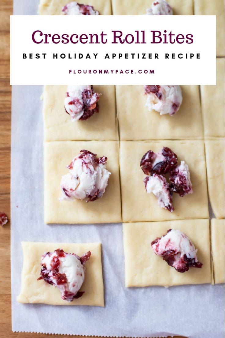 homemade cheese and jelly appetizer bites on parchment paper with text overlay that reads crescent roll bites best holiday appetizer recipe