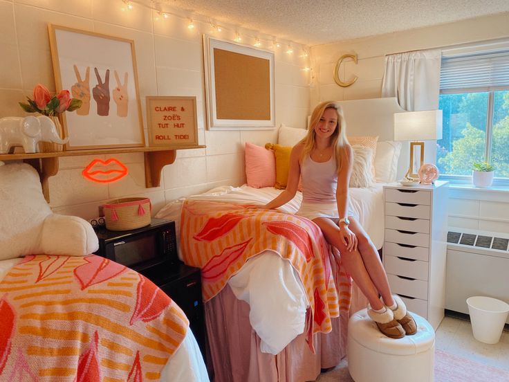 a woman sitting on top of a bed in a bedroom