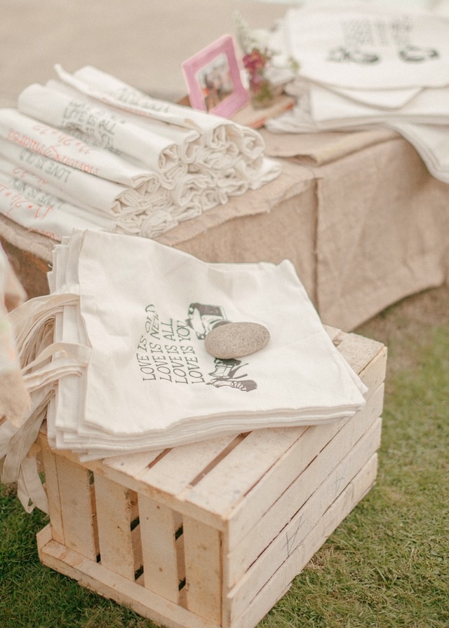 an old wooden crate with napkins and other items on it sitting in the grass