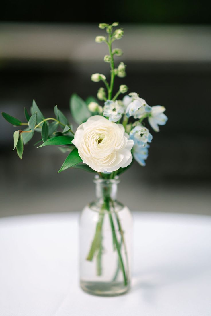 a vase filled with white flowers on top of a table