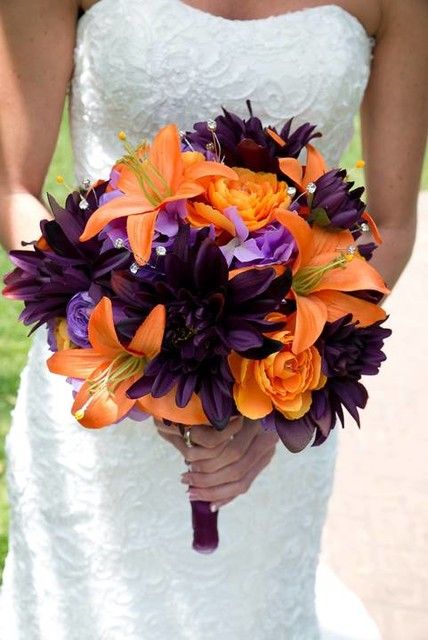 the bride's bouquet is made up of purple and orange flowers