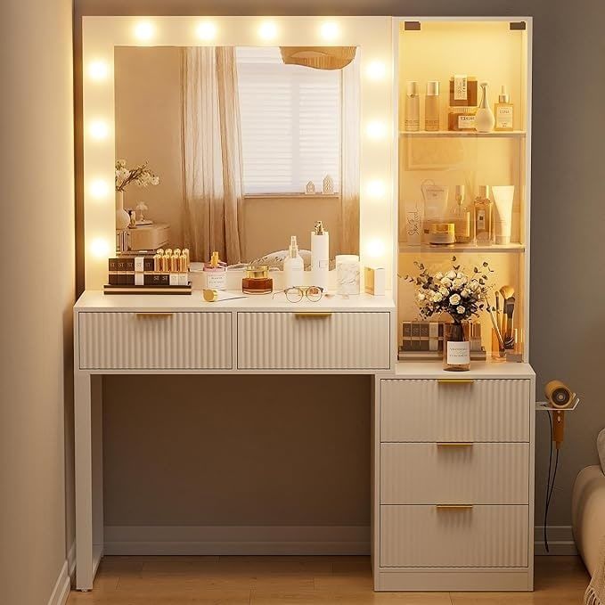 a white vanity with lights on it next to a chair and window in a room