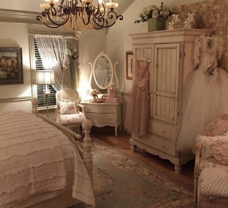 a bedroom with a chandelier, dresser and bed in it's center