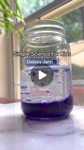 a jar filled with blue liquid sitting on top of a table