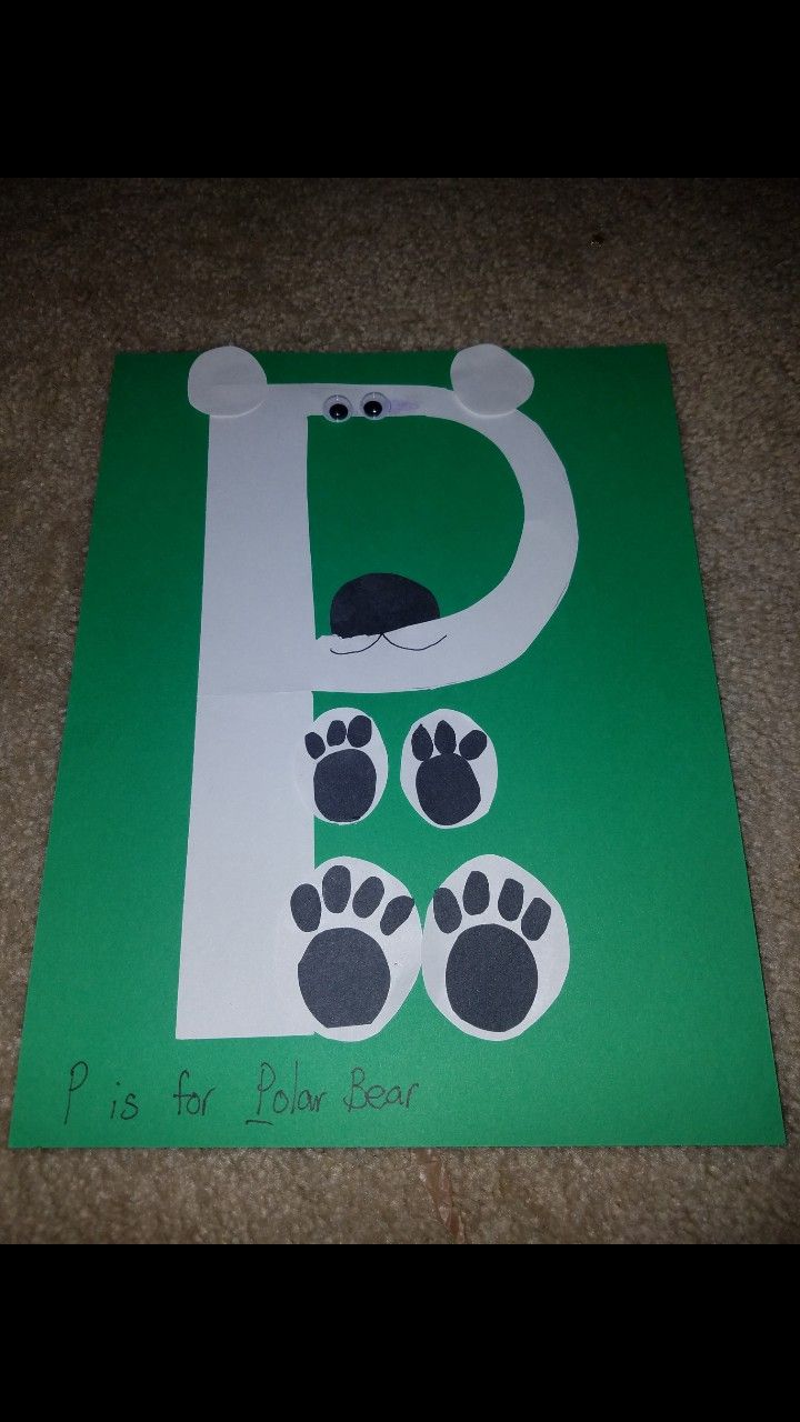 a paper cut out of the letter d with paw prints on it and a bear's head